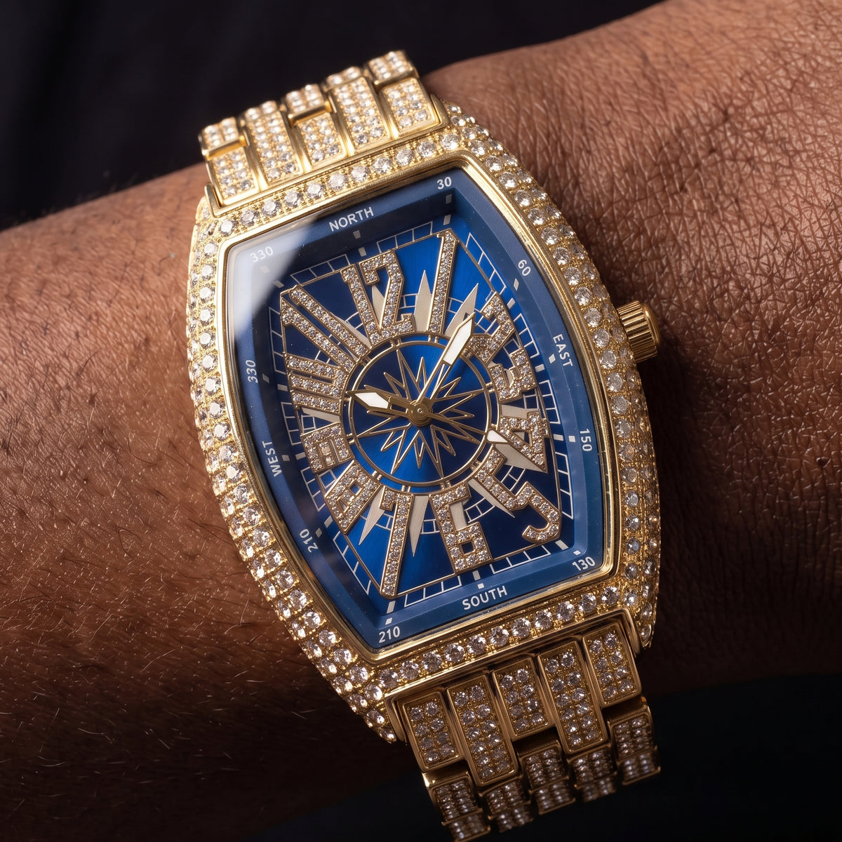 Iced tonneau shaped watch with blue compass dial